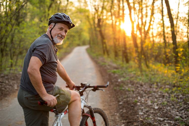 Photo of older man riding a bike