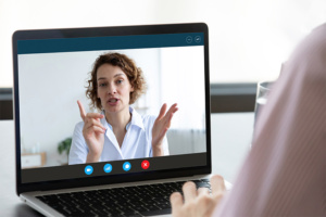 Image of computer screen with counselor speaking to person using computer