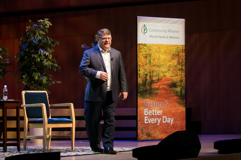 Sean Astin speaking on stage at the Holland Performing Arts Center for Breaking the Silence 2022.