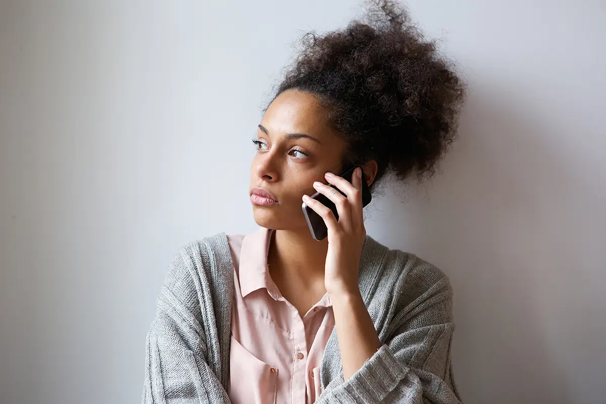 Close up portrait of a young woman talking on mobile phone