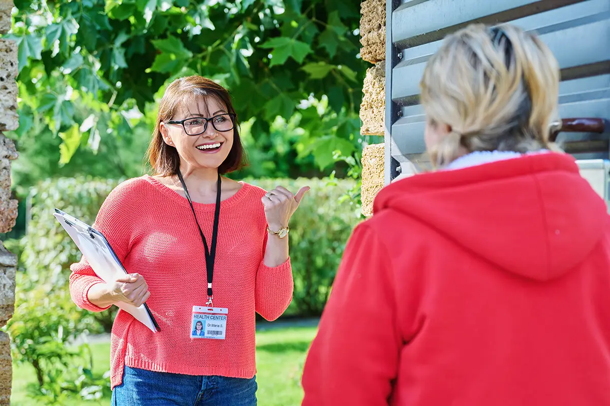 Female health center worker meets middle-aged woman