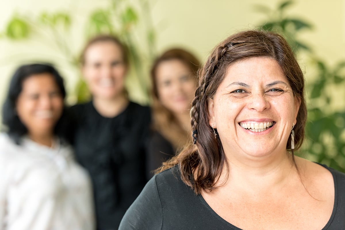 four hispanic mature women posing looking at the camera smiling
