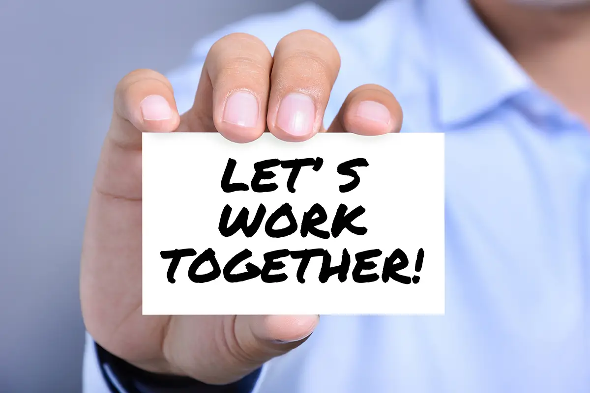 Hand holding words lets work together