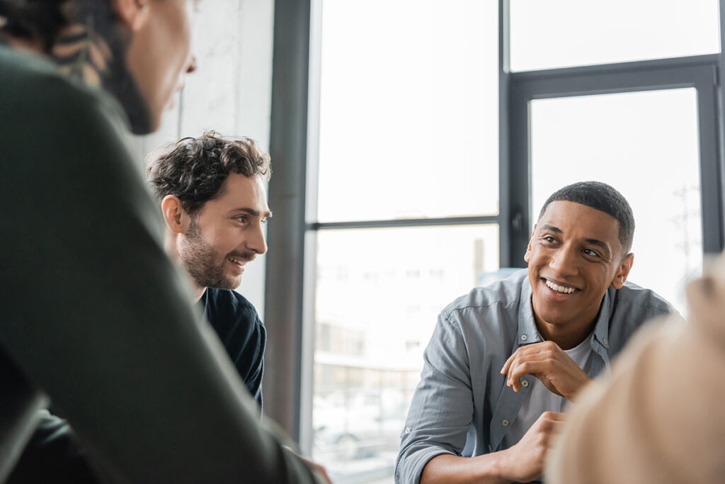 Man smiling and listening in counseling group